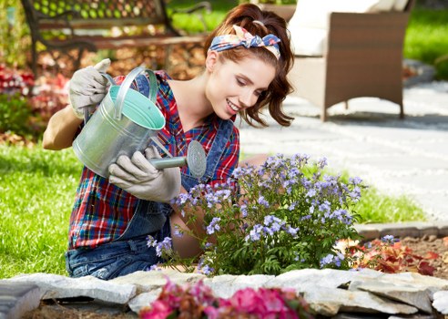 Gardener working in a Willesden garden with tools